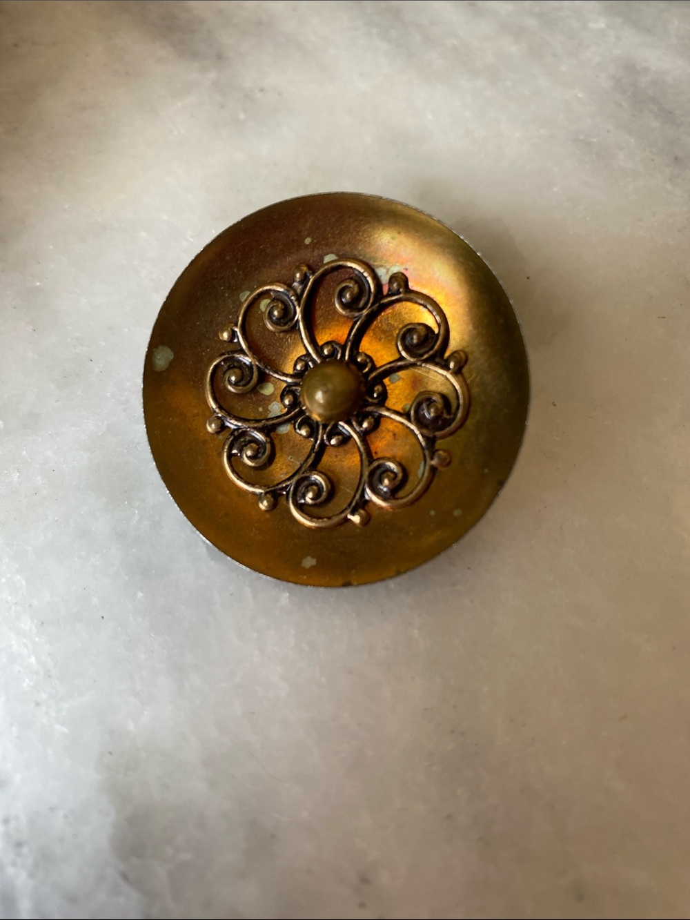 Vintage Goldtone Round Metal Brooch with intricate filigree relief design